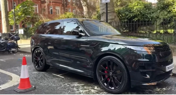 Paint correction result in Oakland — gloss restored on a dark car after machine polishing
