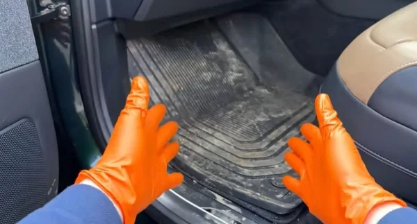 Dirty car floor mats before interior detailing in Oakland