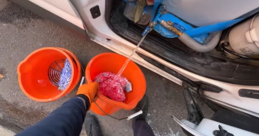 Two-bucket hand wash setup with grit guards used on every Oakland Mobile Detailing exterior service
