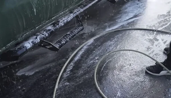 Mobile car wash rinse at a customer's curb in Oakland