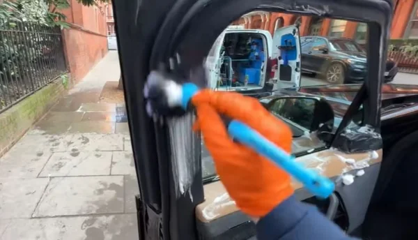 Close detailing work on a vehicle panel in Oakland